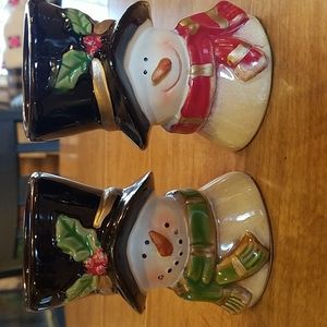 Set of two ceramic snowman candleholders.